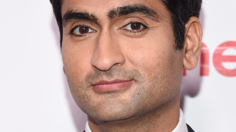 Kumail Nanjiani smiling slightly