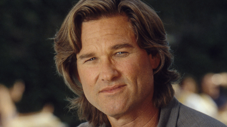 Kurt Russell sitting outside and smiling