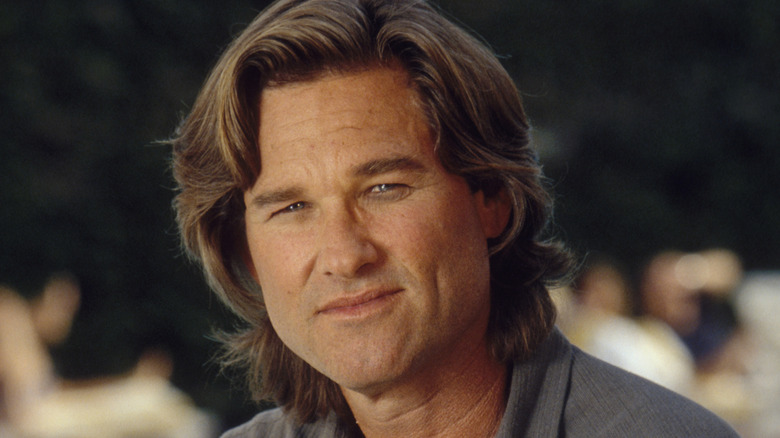 Kurt Russell sitting outside and smiling
