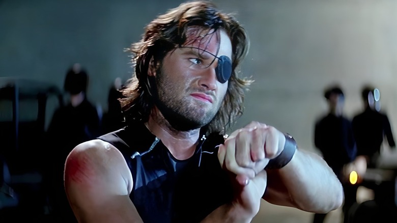 Snake Plissken handcuffed