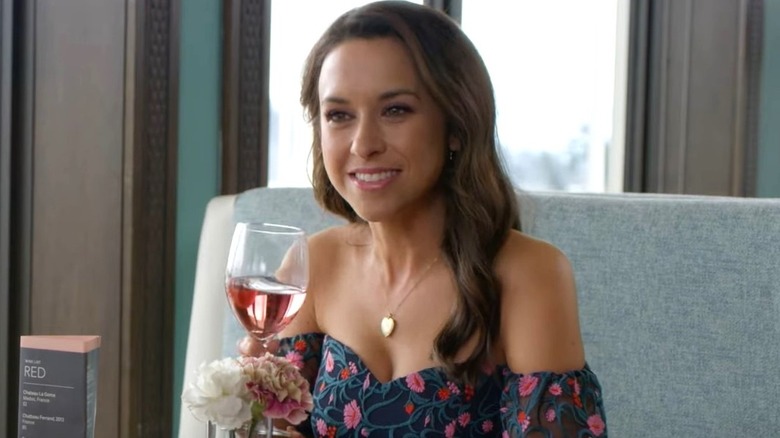 Avery Hastings holding glass of wine