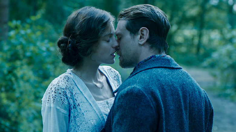 Emma Corrin as Connie Chatterley and Jack O'Connell as Mellors kissing