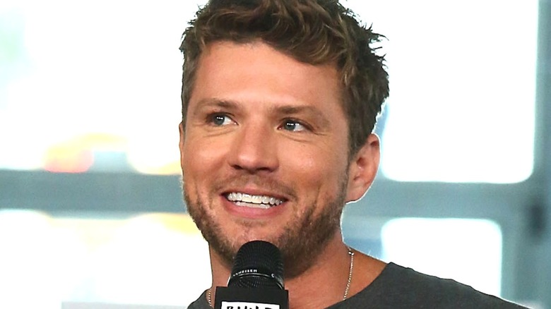 Ryan Phillippe holding microphone smiling