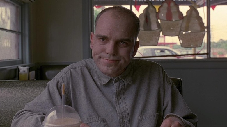 Karl sitting in a restaurant booth in Sling Blade (1996)
