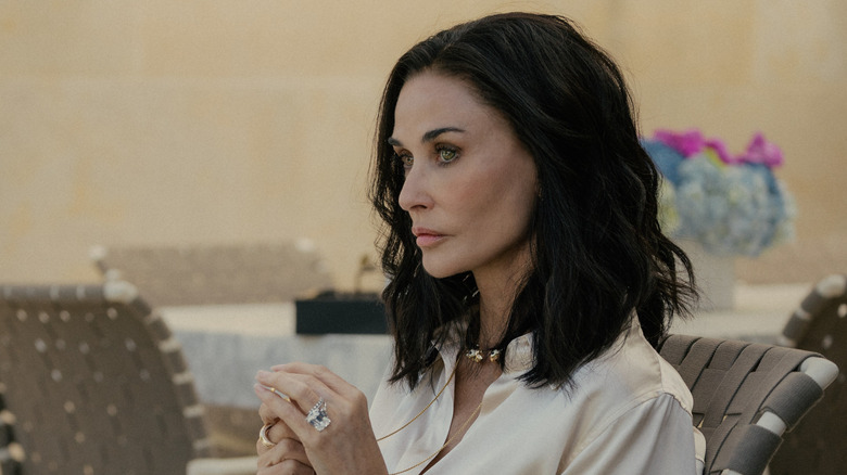 Cami holding her necklace in "Landman"