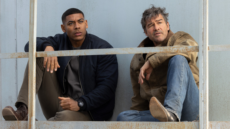 John Stewart and Hal Jordan sit behind a railing on "Lanterns" (2026)