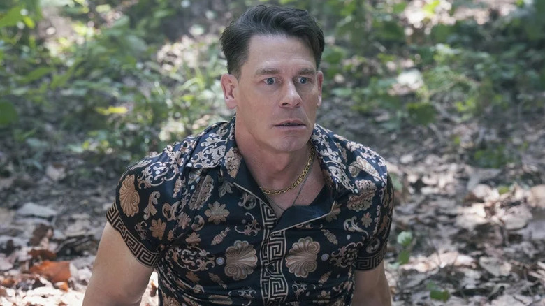 Chris Smith looking shocked and wearing a garish shirt on Peacemaker