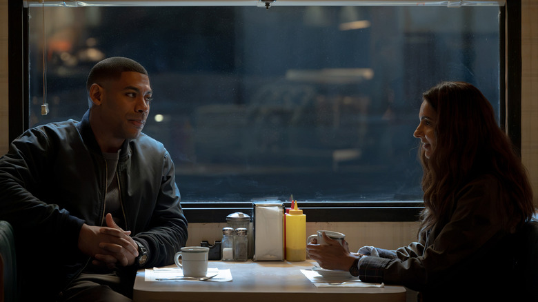 John Stewart and Zoe Macon sitting at a table on "Lanterns" (2026)