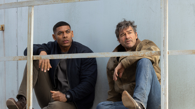 John and Hal sitting and looking at someone in Lanterns