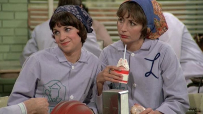 Laverne and Shirley sitting at a table