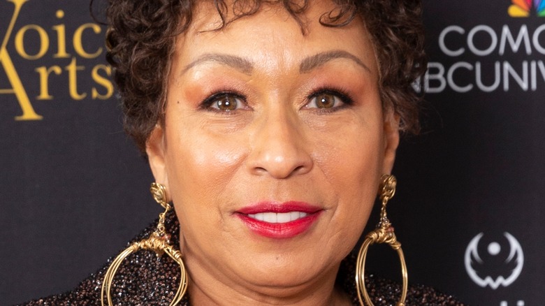 Tamara Tunie wearing large gold earrings at event