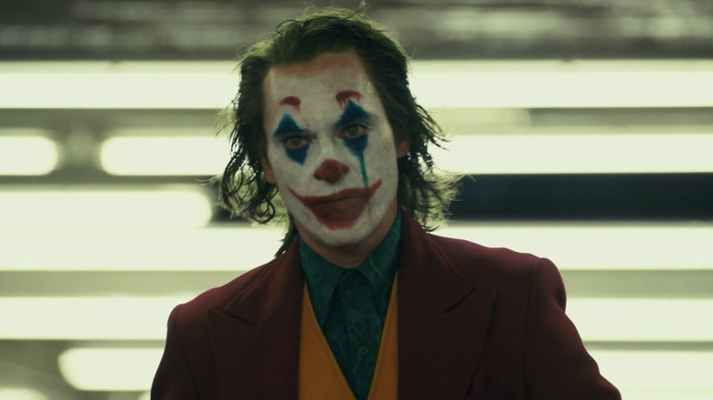 Joker walking with his face painted to look like a clowj