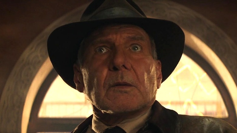 Indiana Jones looking nervous after snapping his whip in Indiana Jones and the Dial of Destiny