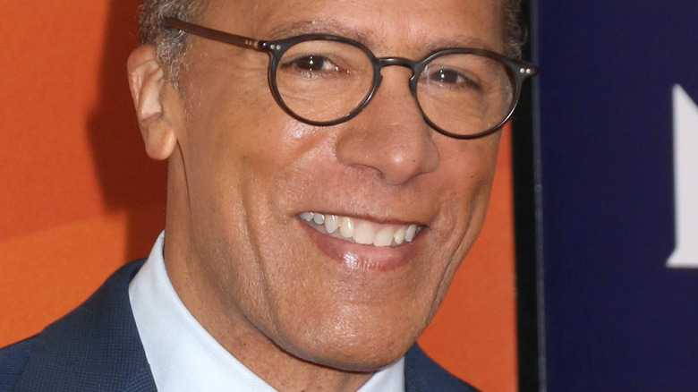 Lester Holt smiling and wearing glasses