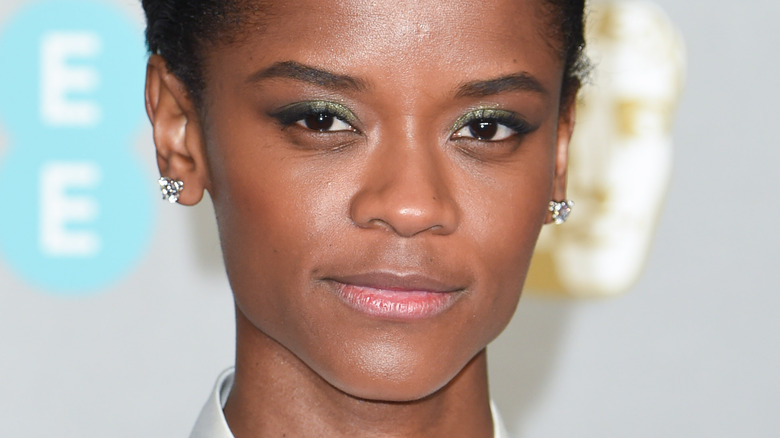 Letitia Wright smiling faintly