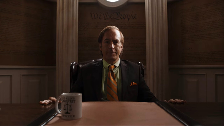 Saul Goodman sits at his desk