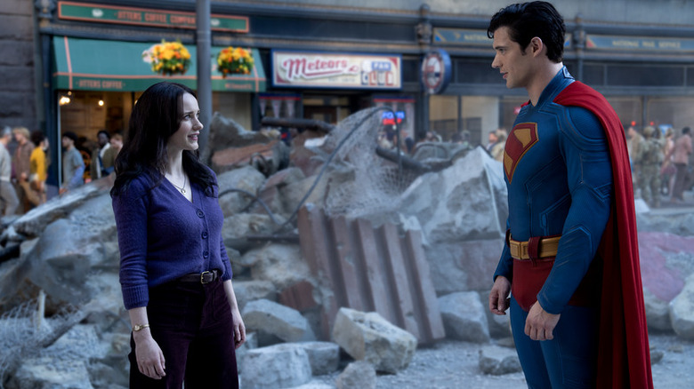 Superman with Lois Lane among rubble in Superman (2025)