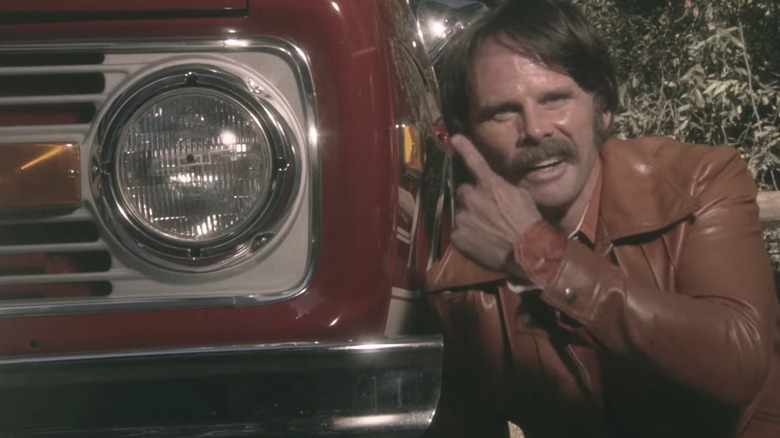 John Bronco smiling with car
