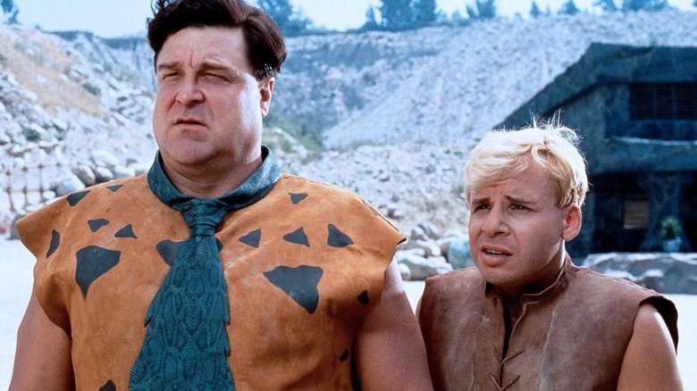 Fred Flintstone and Barney Rubble standing