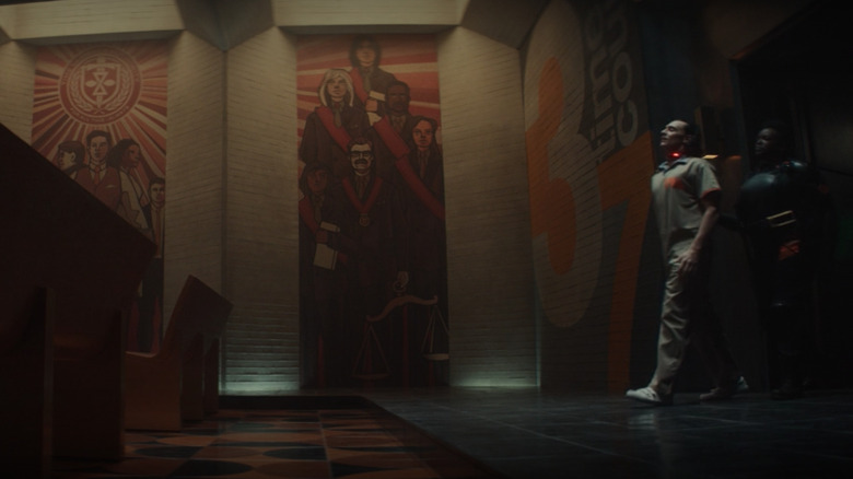 Loki walking past the TVA mural