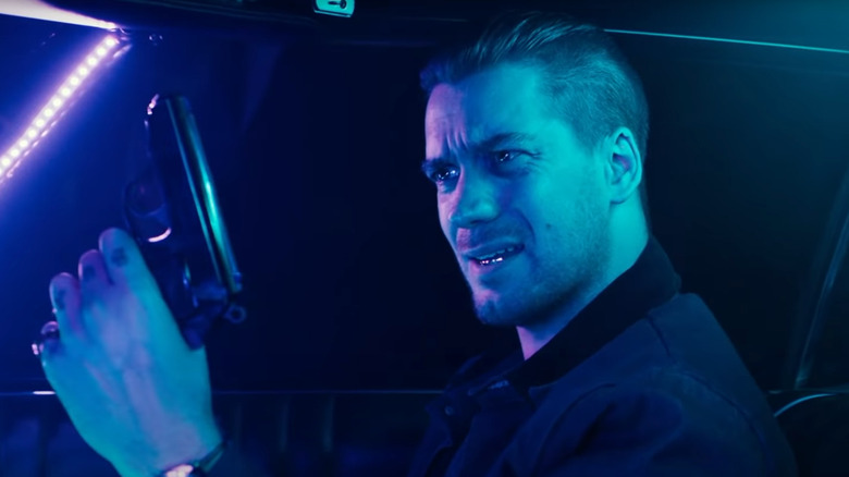 Miles Turner brandishes a gun