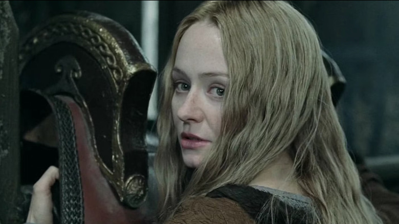Eowyn putting a saddle on a horse