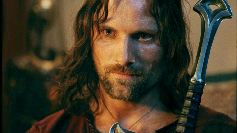 Viggo Mortensen as Aragorn carrying Andúril in The Lord of the Rings