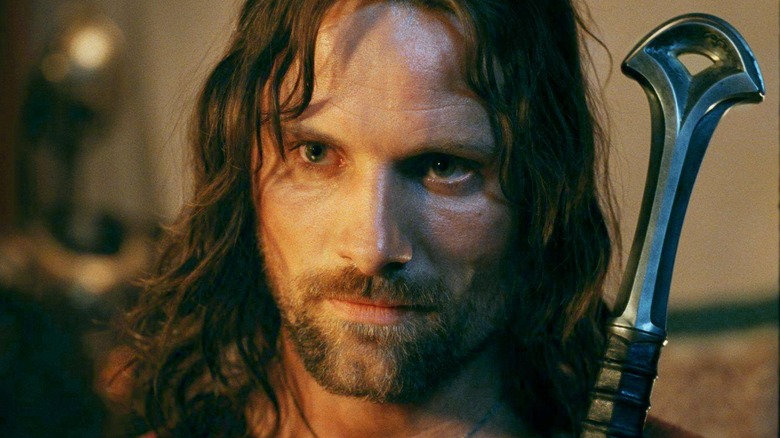 Viggo Mortensen as Aragorn carrying Andúril in The Lord of the Rings