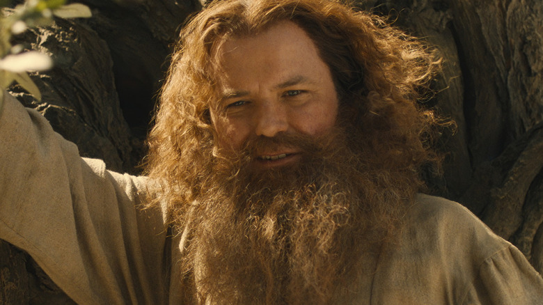 Tom Bombadil leans on a tree in 