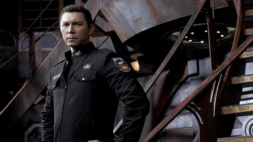 Lou Diamond Phillips stands in a futuristic control room