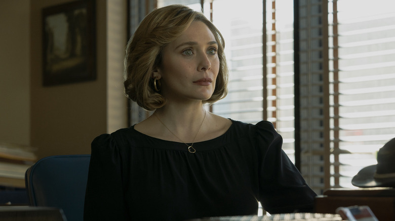Candy Montgomery sitting in office (2023)