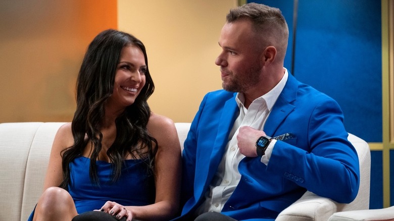 Danielle Ruhl and Nick Thompson talking on a couch in Love is Blind