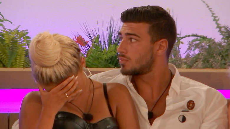 contestants Molly-Mae Hague and Tommy Fury sitting in a couple and reacting to many shock reveals from Casa Amor in 