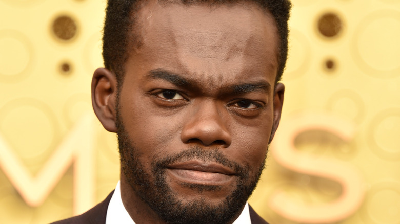 William Jackson Harper in front of a yellow background