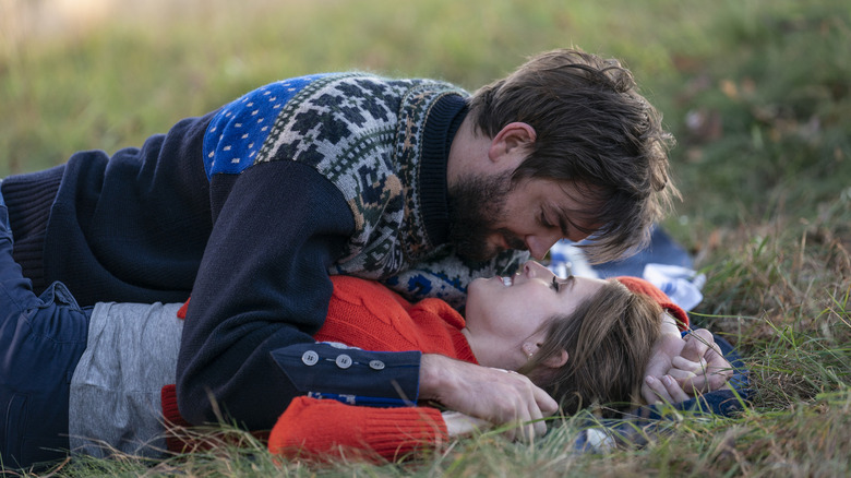 Nick Thune and Anna Kendrick lying in the grass