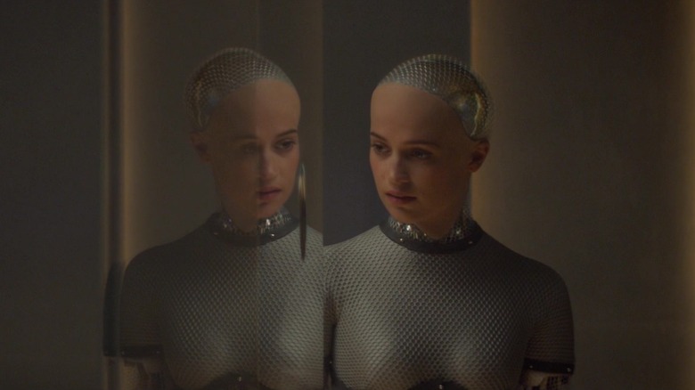Ava is reflected in a window in "Ex Machina" (2015)