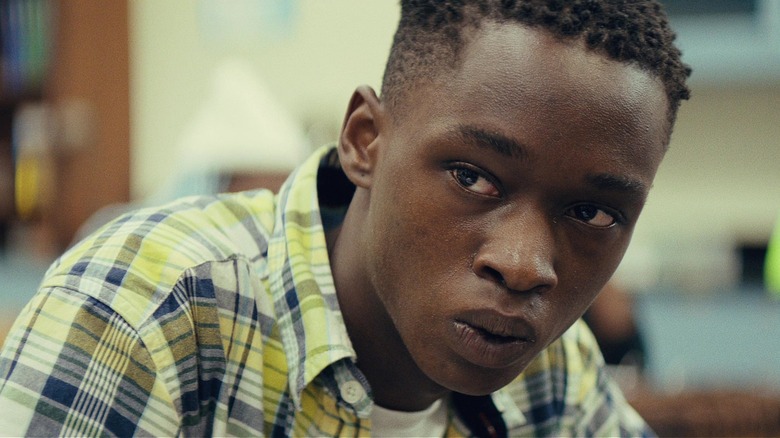 Teenage Chiron sitting in class hunched over in Moonlight (2016)