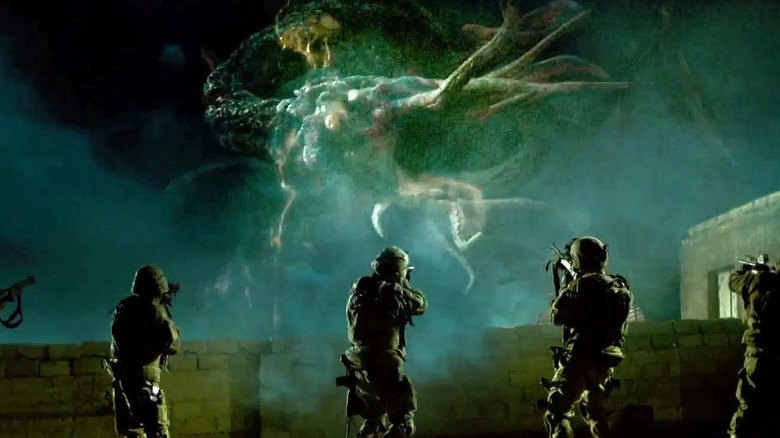 soldiers aims guns at a tentacled creature in "Monsters" (2010)