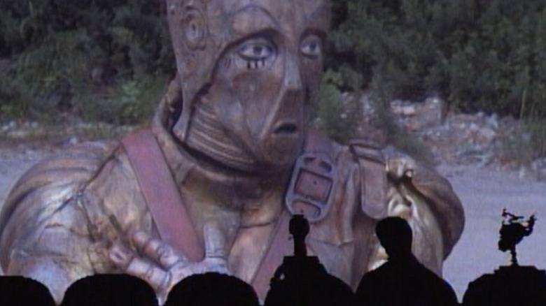 Joel, Crow T. Robot, and Tom Servo watching "Robot Holocaust" in "Mystery Science 3000"