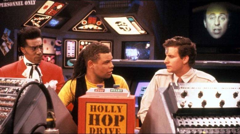 Cat, Lister, Rimmer, and Holly speaking together in "Red Dwarf"