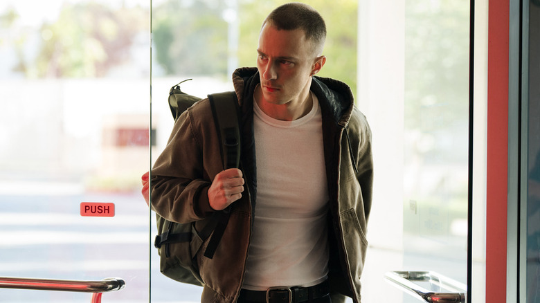 Cary frowning and entering a building in "Lucky" (2026)