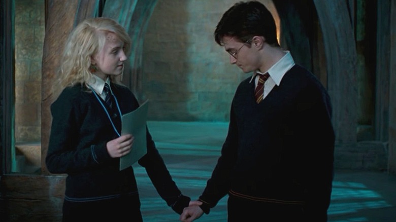 Luna Lovegood holding Harry Potter's hand