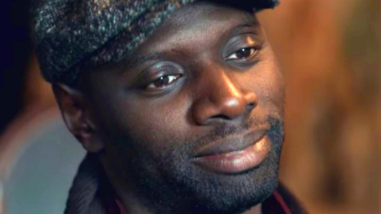 Assane Diop wearing a flat cap