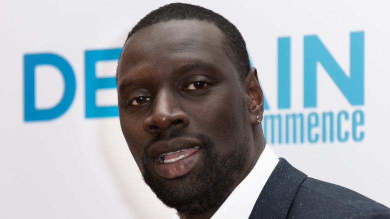 Omar Sy looking into camera