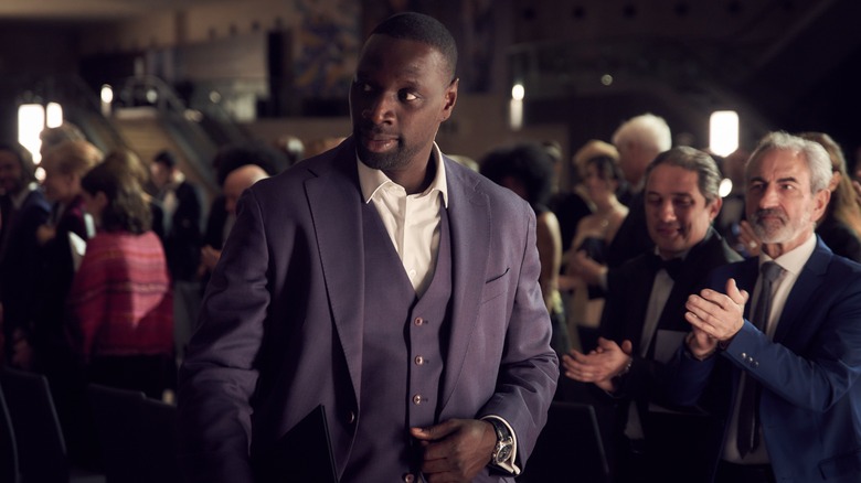Assane Diop purple suit walking