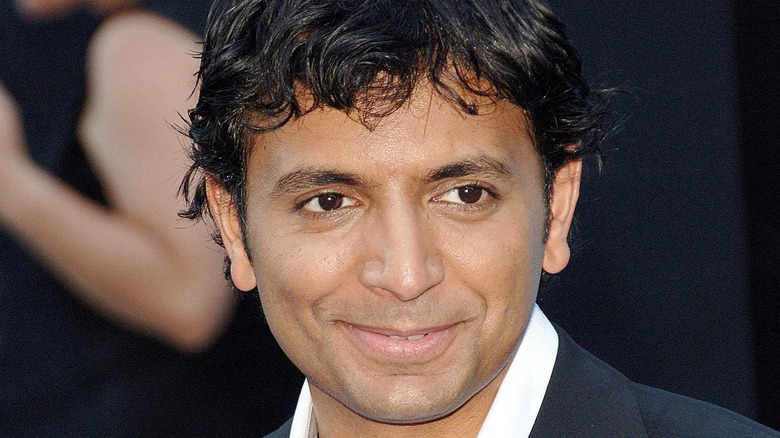 M. Night Shyamalan smirking