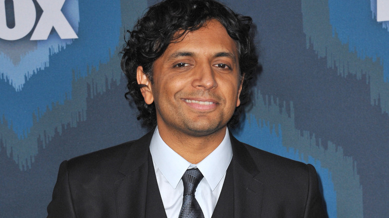 M. Night Shyamalan smiling on the red carpet