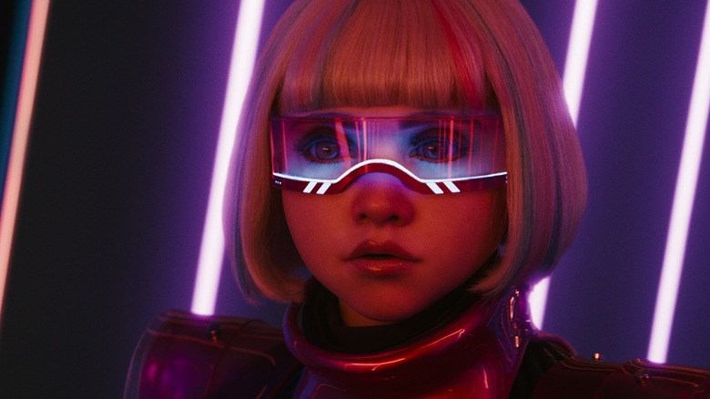 M3GAN wearing a visor and wig by neon lights in 