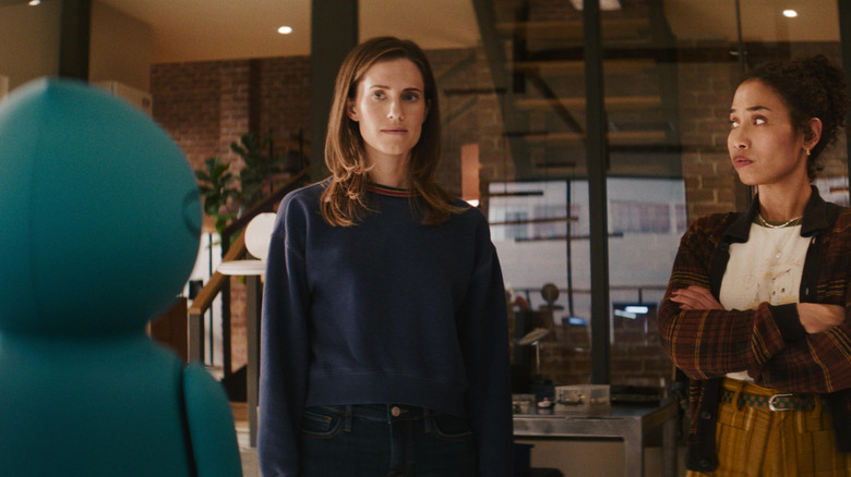 Gemma and Tess facing a round blue robot in 