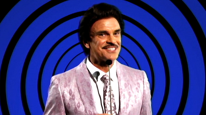Man smiling creepily in "Ozzy's Dungeon" in "V/H/S/99"